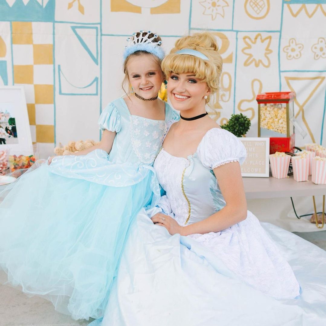 Cinderella doing a curtsy with birthday girl